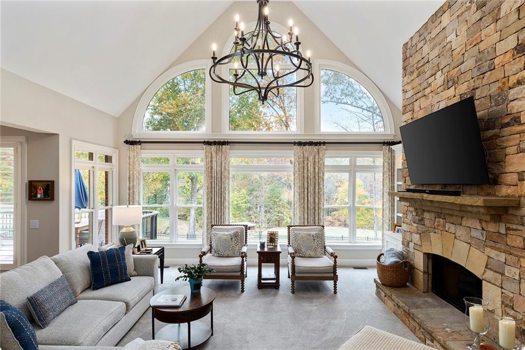 219 Morning Mist Way Woodstock, GA 30189 - Photo 18 of 72 a living room with furniture a fireplace and a flat screen tv