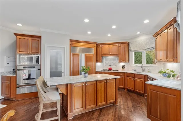 a view of a dining room with furniture wooden floor and chandelier