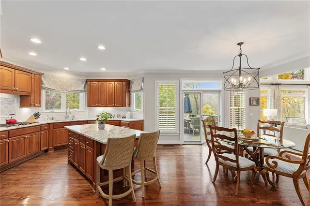 a living room with furniture a chandelier and a window