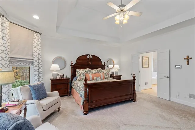 a spacious bedroom with a bed and a couch