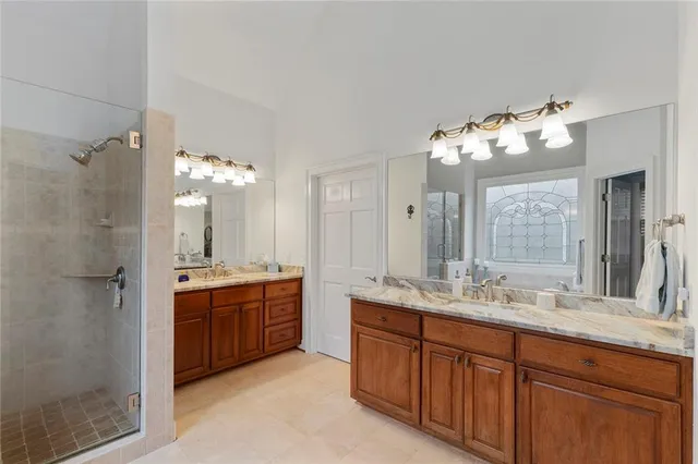 a bathroom with a sink vanity granite and toilet