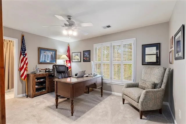 a living room with furniture fireplace and a large window