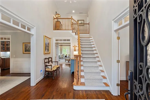 a view of entryway and hall with wooden floor