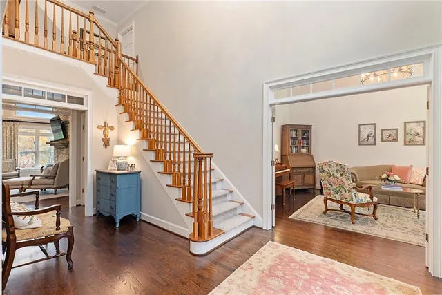 a view of entryway and hall with wooden floor