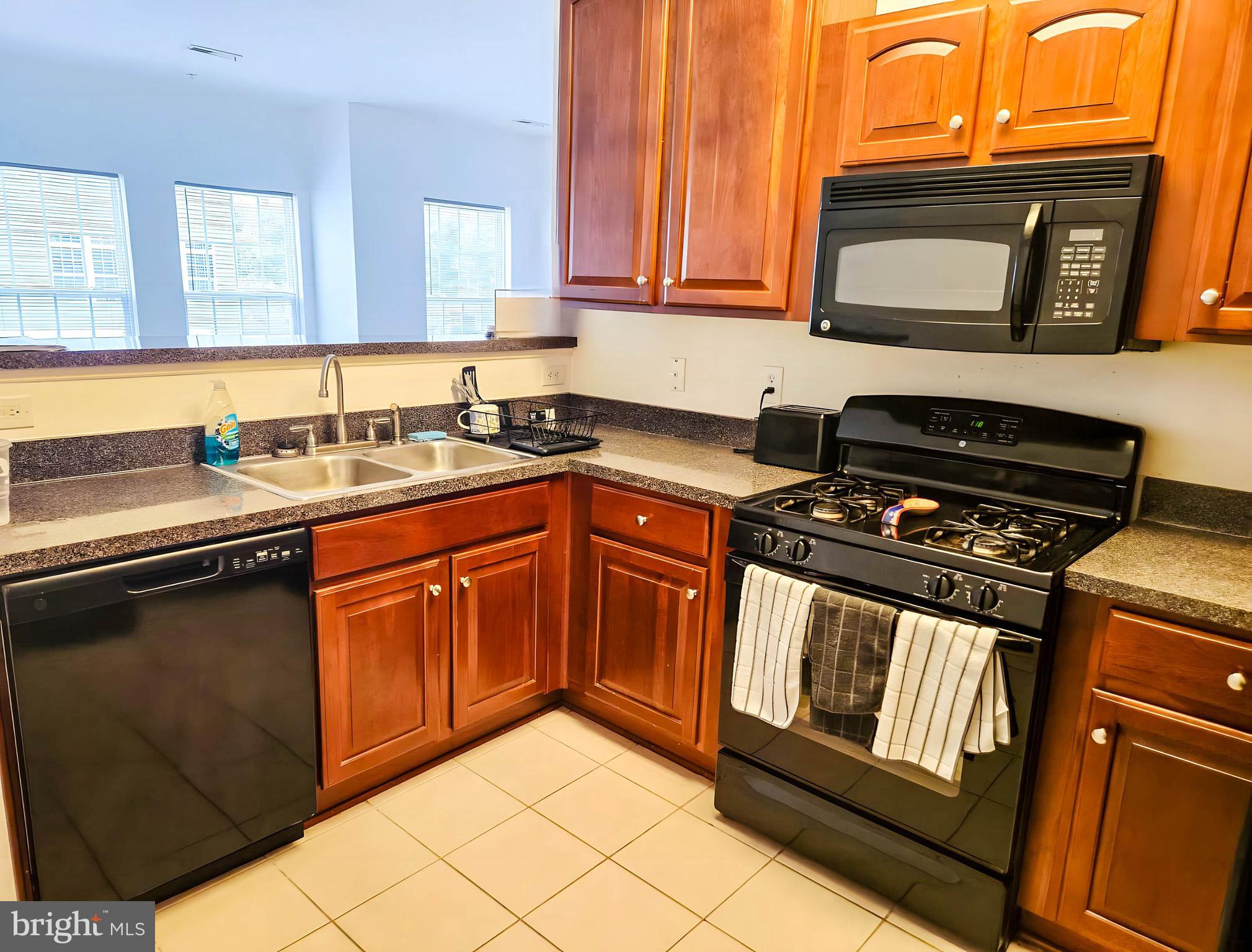 7 Fox Court Riverside, NJ 08075 - Photo 7 of 21 a kitchen with granite countertop a stove top oven microwave and cabinets