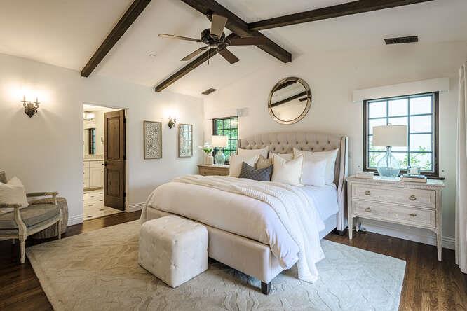 236 Amherst Avenue San Mateo, CA 94402 - Photo 13 of 35 a spacious bedroom with a bed and a chandelier