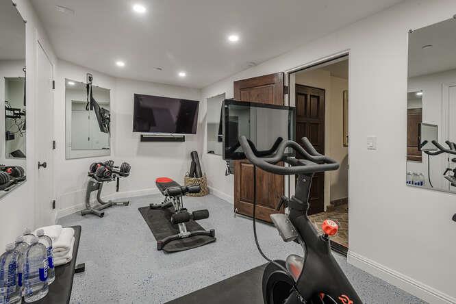 236 Amherst Avenue San Mateo, CA 94402 - Photo 31 of 35 a room with gym equipment and a flat screen tv