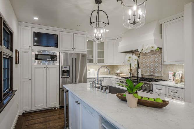 236 Amherst Avenue San Mateo, CA 94402 - Photo 9 of 35 a kitchen with stainless steel appliances granite countertop a refrigerator a stove a oven a dining table and chairs with wooden floor