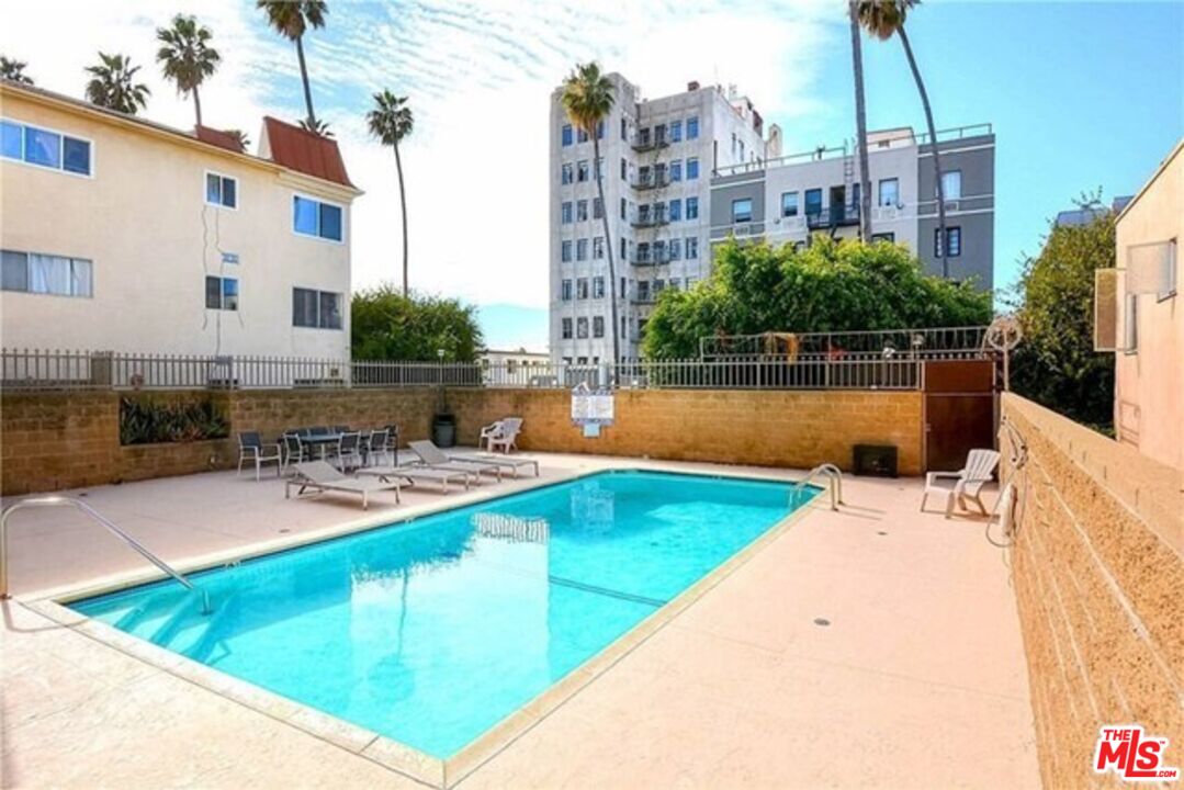 533 South St Andrews Place, Unit 321 Los Angeles, CA 90020 - Photo 16 of 16 a view of a swimming pool with outdoor seating and plants
