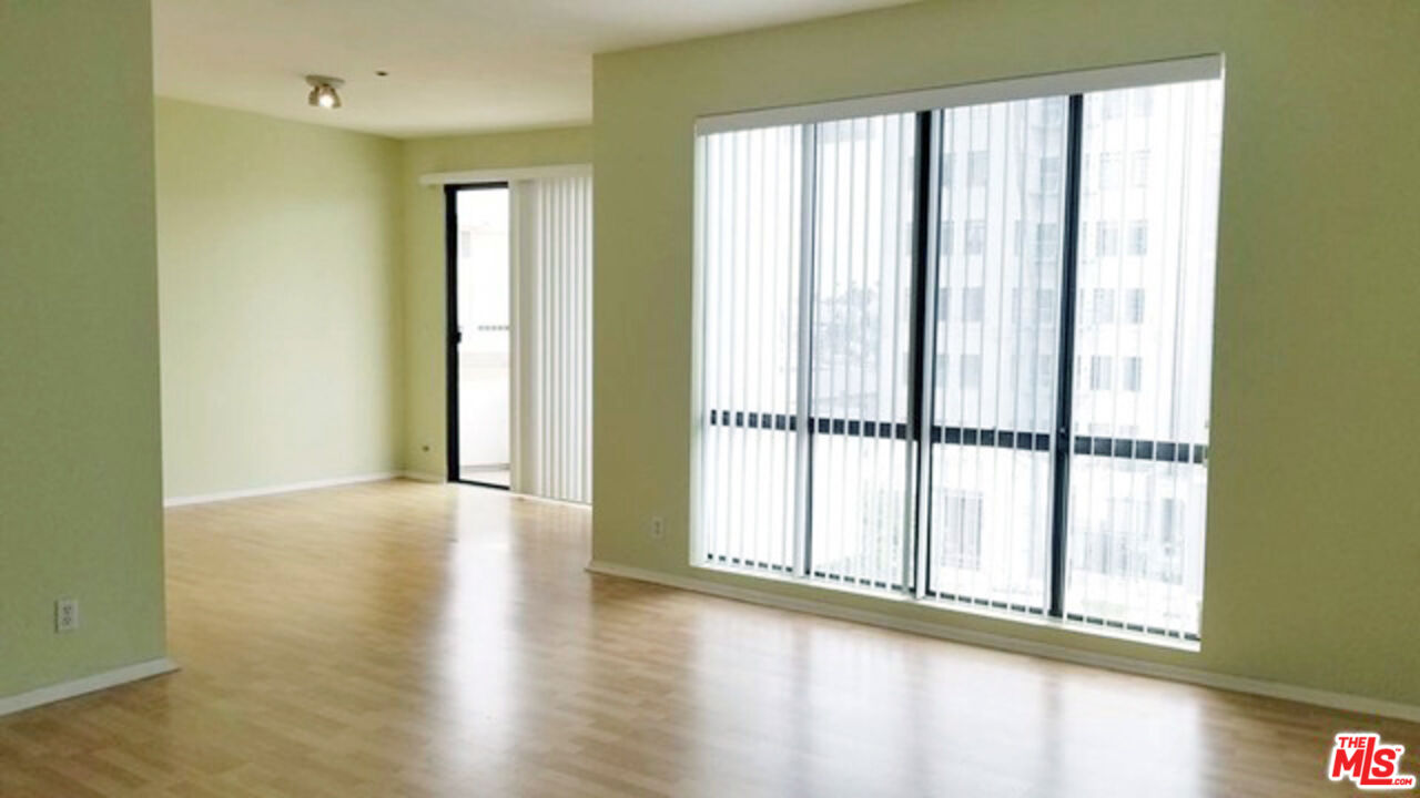 533 South St Andrews Place, Unit 321 Los Angeles, CA 90020 - Photo 3 of 16 a view of an empty room with wooden floor and a window