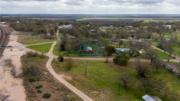 an aerial view of a houses with a yard