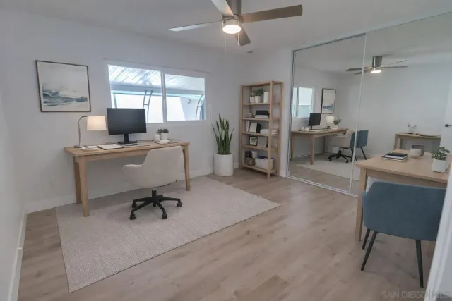 a view of a livingroom with workspace and a window