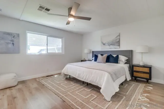 a bedroom with a bed and a lamp