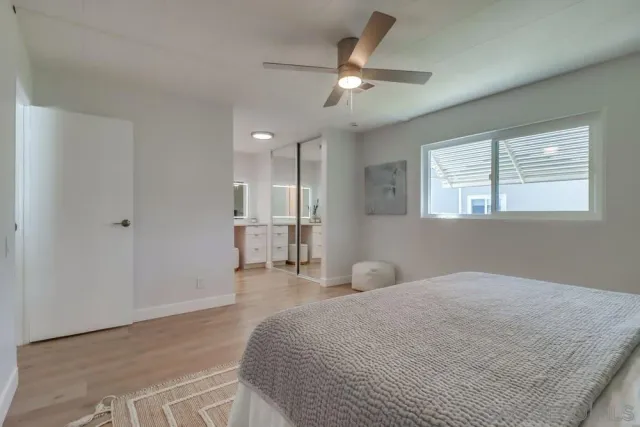 a spacious bedroom with a bed and a chandelier