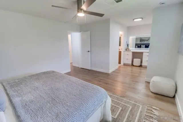 a spacious bedroom with a bed and a couch