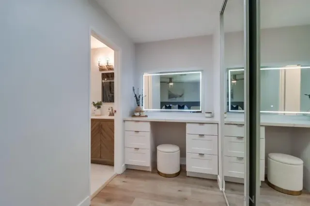 a spacious bathroom with a toilet sink and mirror