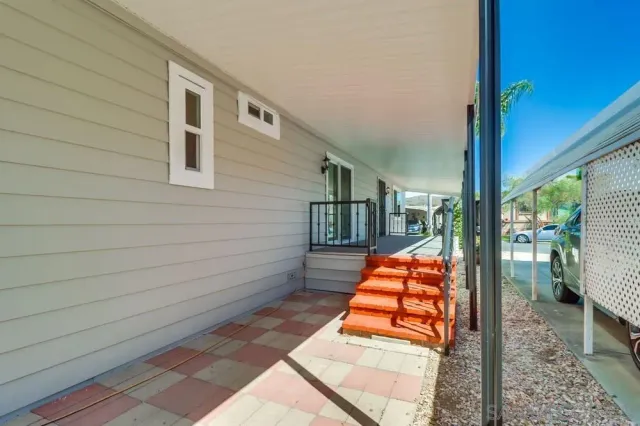 a wooden bench sitting in front of a building