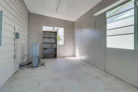 an empty room with a fireplace and cabinet