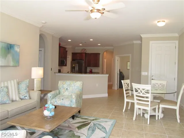 a living room with furniture and kitchen view