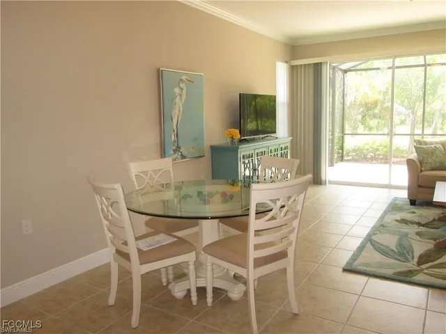 a dining room with furniture and a flat screen tv
