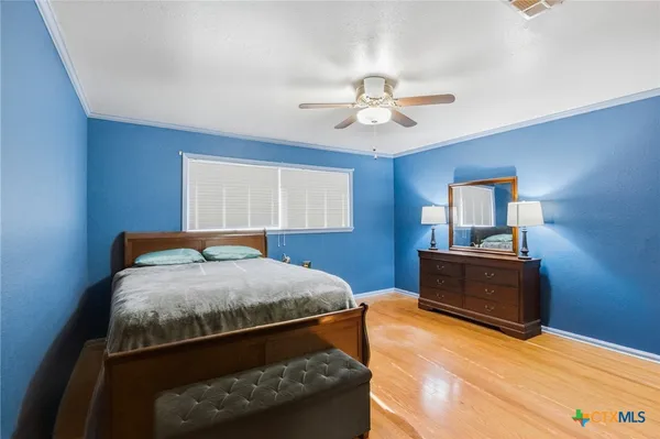 a bed room with a bed and a television