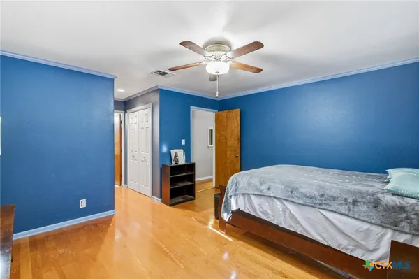 a bedroom with a bed and a chandelier