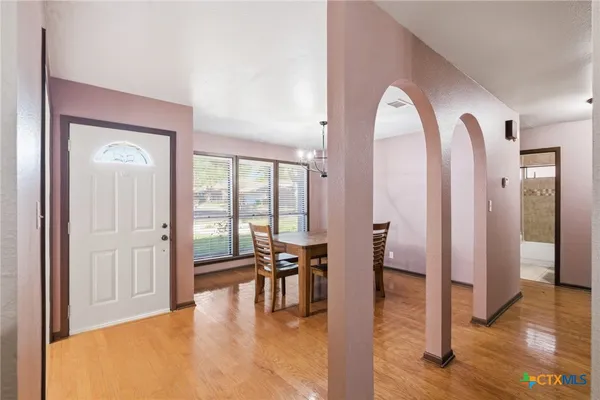 a view of a livingroom with furniture and floor to ceiling window
