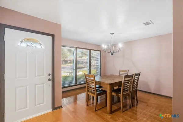 a view of a dining room with furniture window and wooden floor