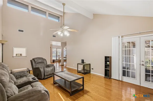 a living room with furniture and a chandelier