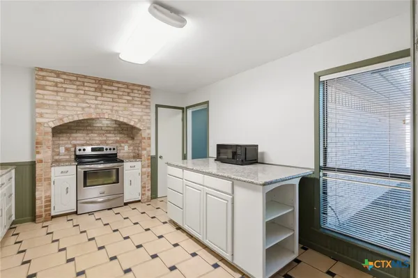 a kitchen with a stove and a sink