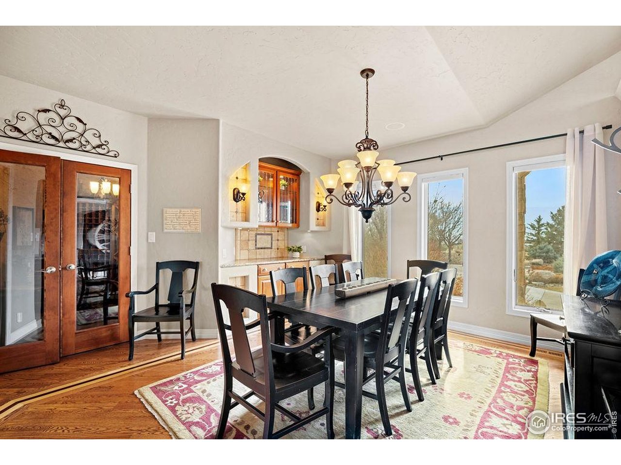 46 Sunset Lane Fort Morgan, CO 80701 - Photo 30 of 49 a view of a dining room and livingroom with furniture wooden floor a chandelier