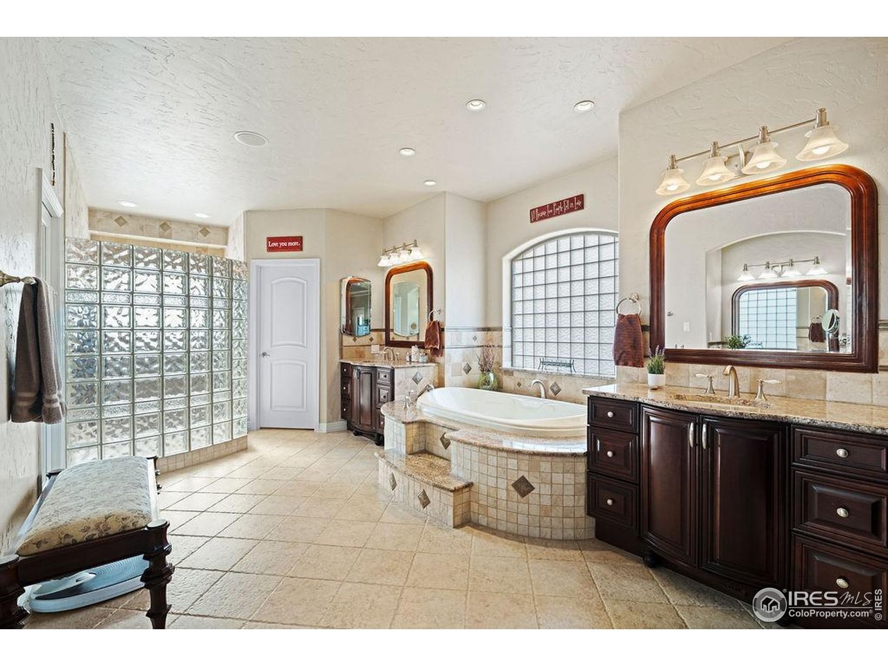 46 Sunset Lane Fort Morgan, CO 80701 - Photo 36 of 49 a spacious bathroom with a double vanity sink a mirror and a bathtub