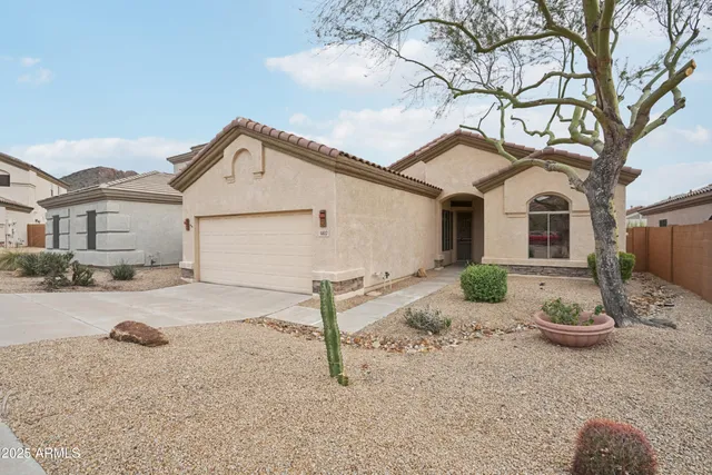 a view of a house with a yard covered in snow
