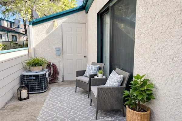 a outdoor living space with furniture and a potted plant