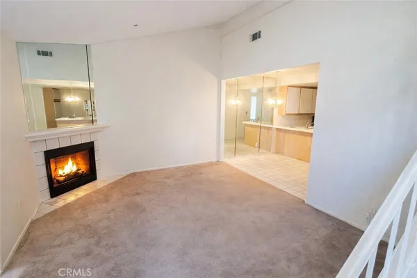 a view of an empty room and fire place