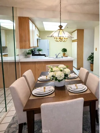 a view of a dining room with furniture a chandelier and wooden floor