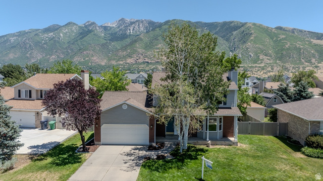 11957 Noelle Road Sandy, UT 84092 - Photo 3 of 38 Mountain backdrop with mature trees and a sloped, manicured front lawn