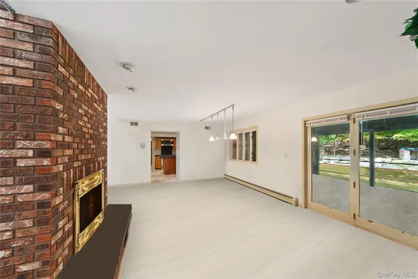 a view of an empty room with a fireplace