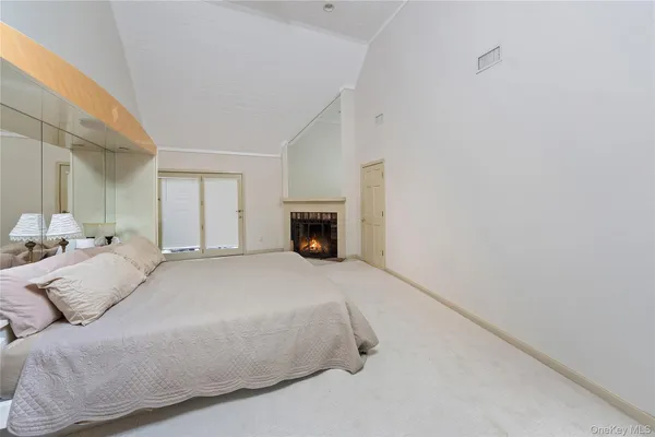 a bedroom with a bed and a fireplace