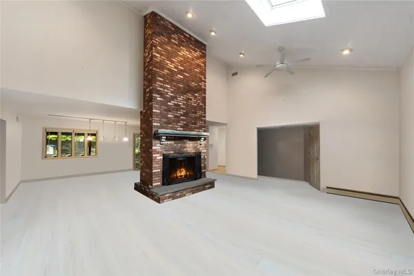 a view of an empty room with a fireplace
