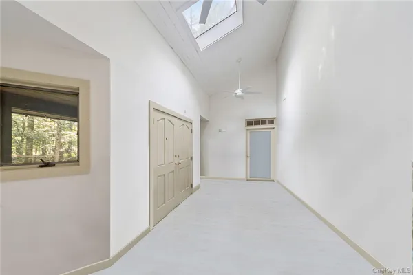 an empty room with windows and closet