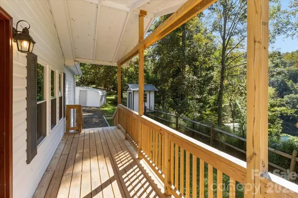 a view of balcony with wooden floor and fence