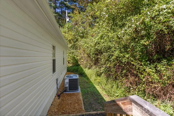 a pathway of a house with wooden fence