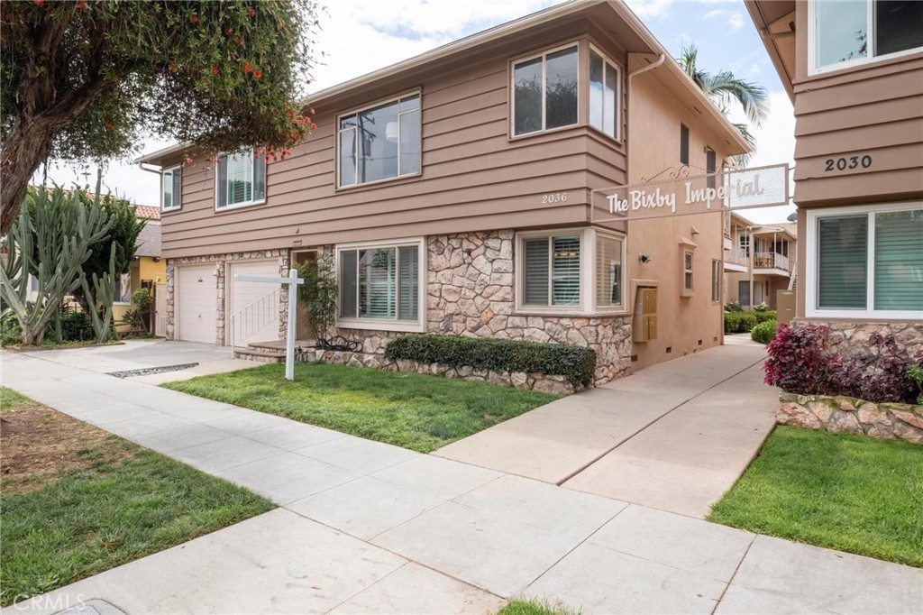 2036 East 3rd Street, Unit 1 Long Beach, CA 90814 - Photo 1 of 41 a front view of a house with a yard and potted plants