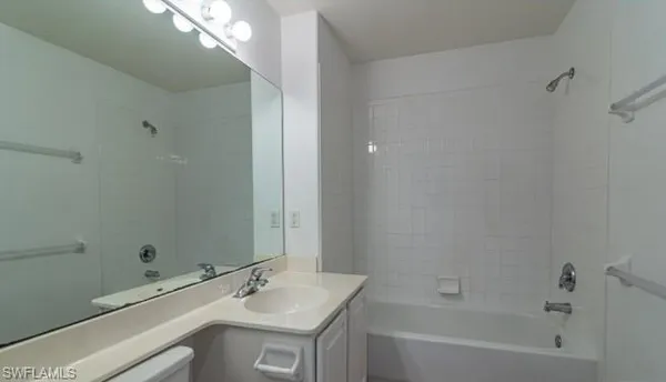 a bathroom with a bathtub a sink and a mirror