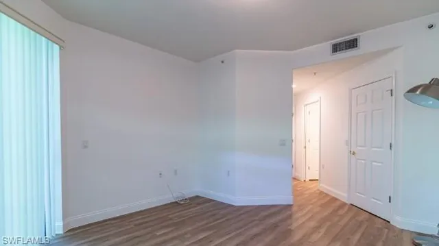 a view of a room with wooden floor