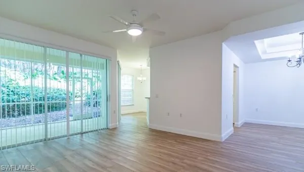 a view of a room with wooden floor and fan