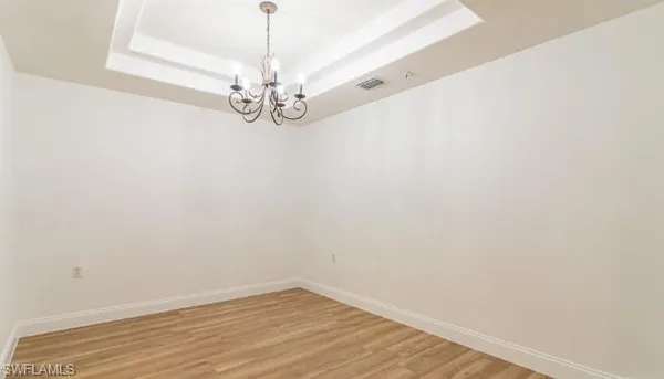 a view of a chandelier fan and wooden floor