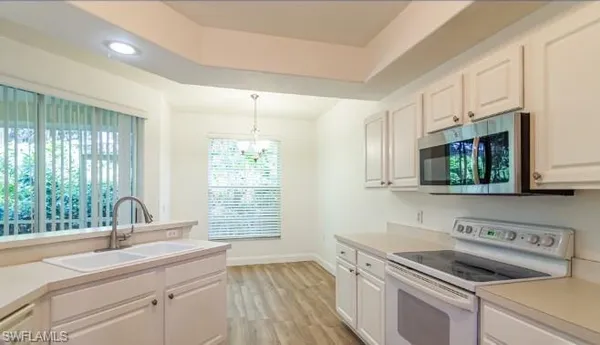 a kitchen with a sink stove and microwave