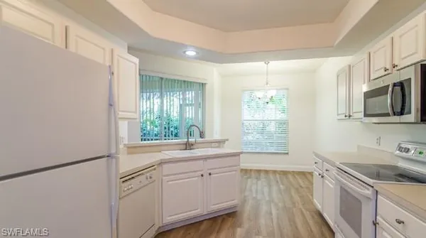 a kitchen with a sink stove and microwave